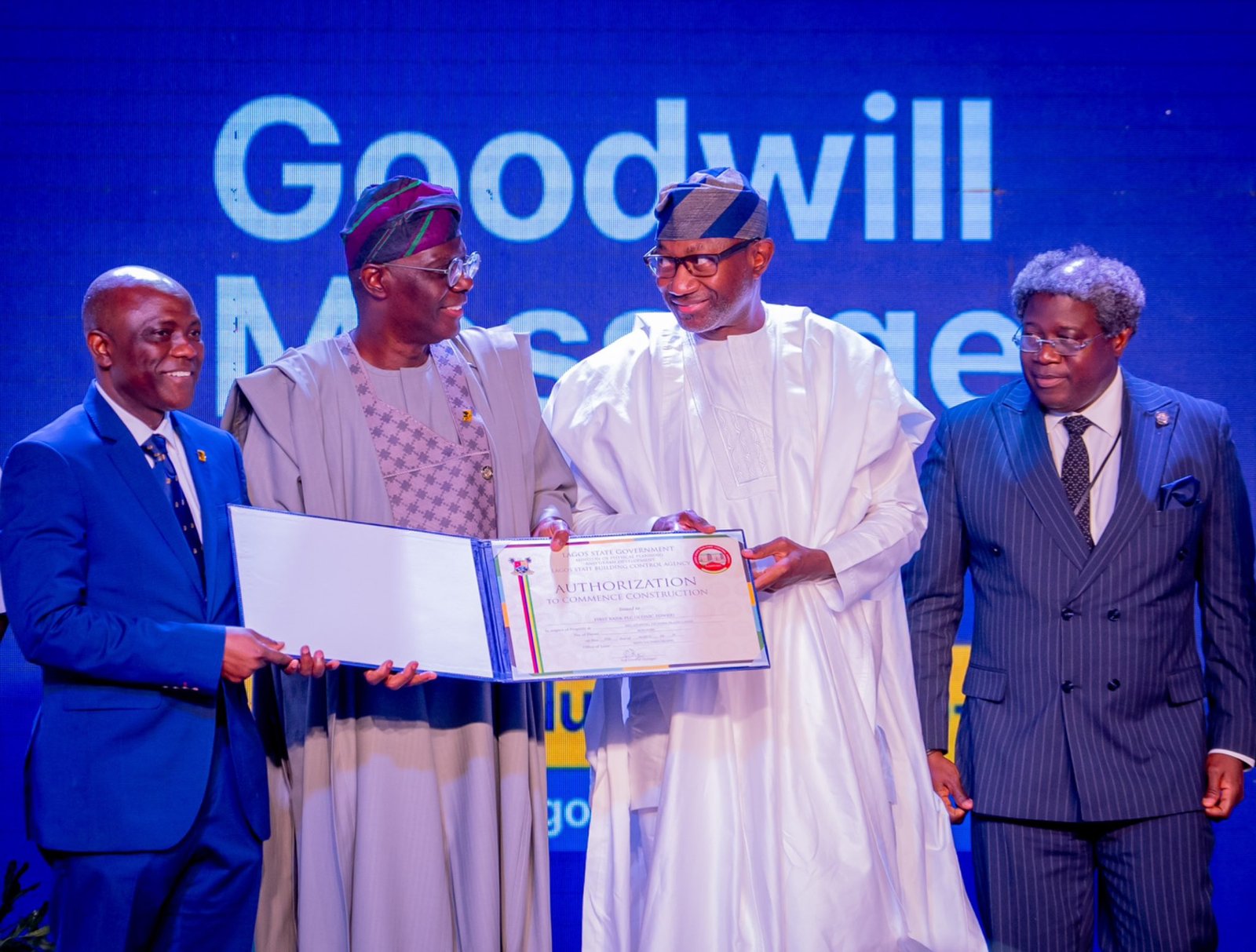 Mr Sanwo- Olu presenting the approval certificate to Mr Otedola 