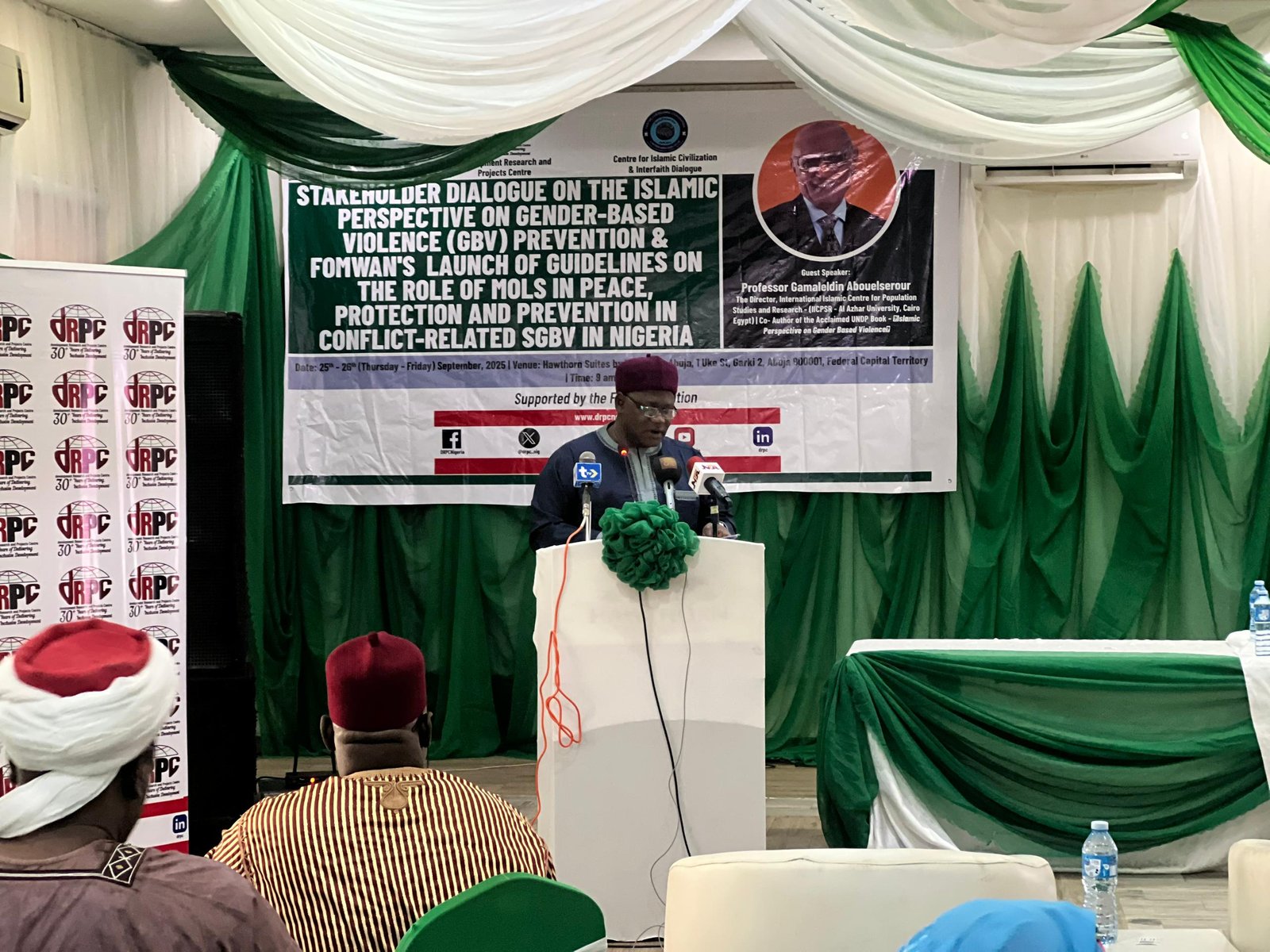 A member of the board of the dRPC, Sani Garko, a professor, takes the podium to deliver the welcome address