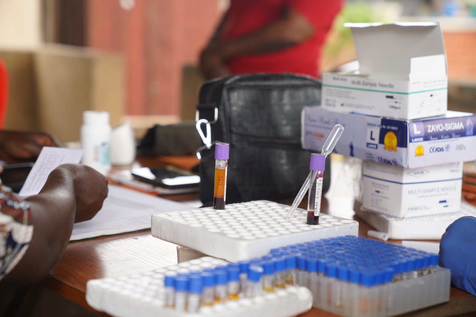Medical supplies, including test tubes, sample collection needles, and other equipment, are arranged on a table at the Lugbe Primary Health Care Centre in Abuja, Nigeria. July 29, 2025.