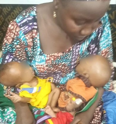 A mother cradles her fragile twins (not child) at the stabilisation centre in Katsina. (Photo: Ogalah Dunamis)