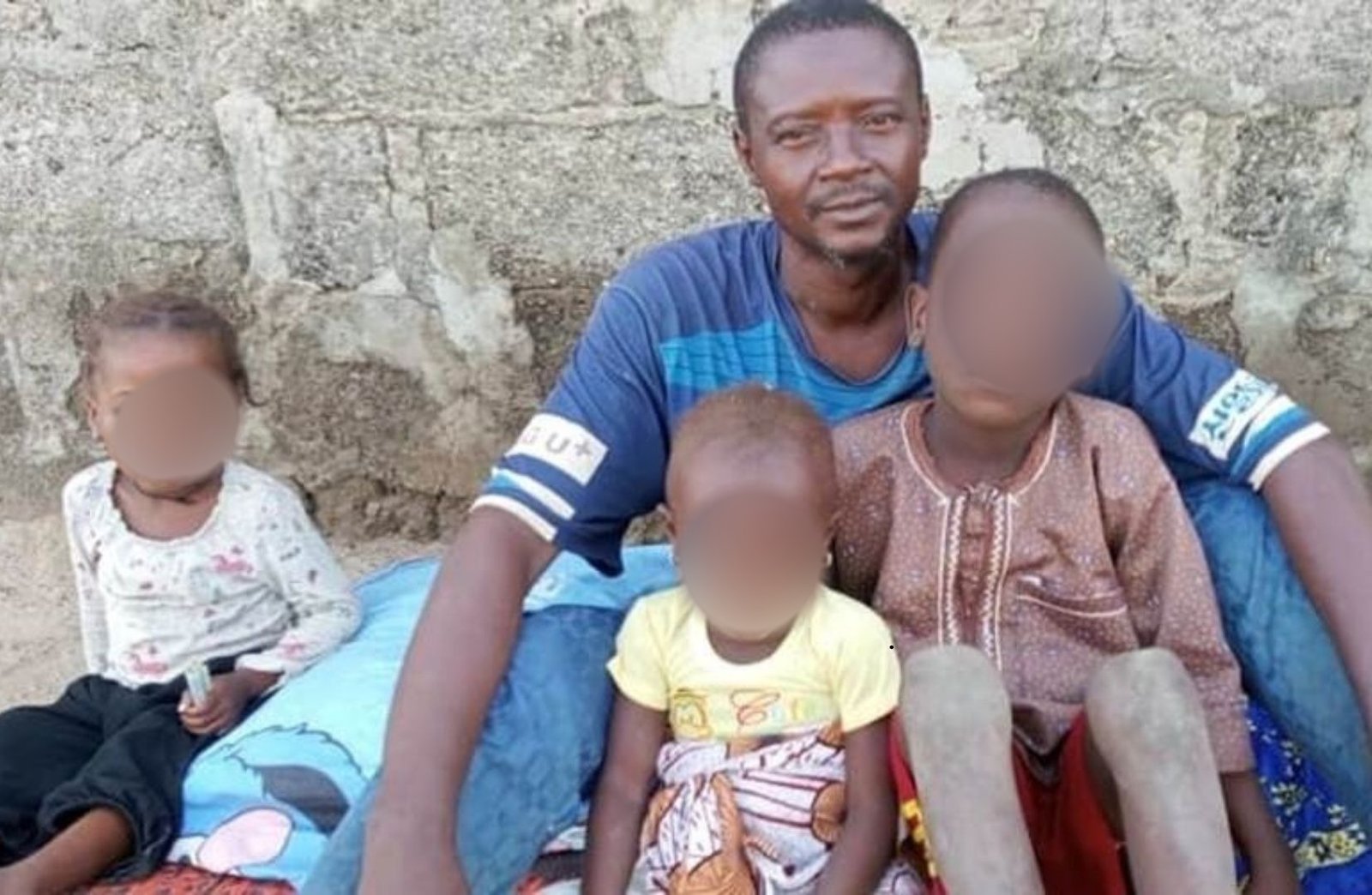 Mr Abdullahi with the kids he had with his late wife, Hadiza / Yakubu Mohammed