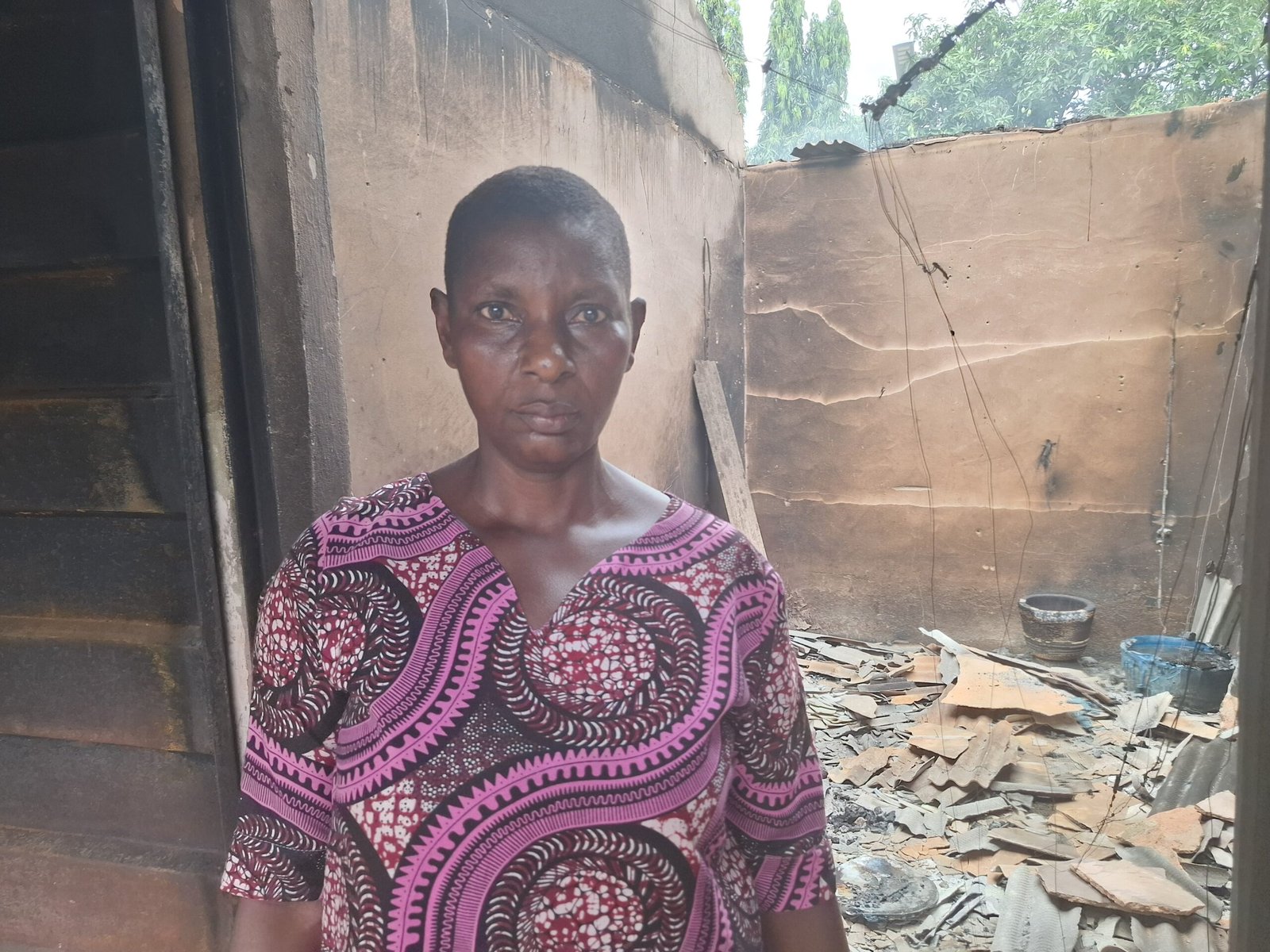 Emah James standing by the remains of her shop