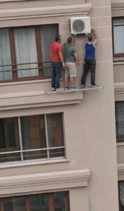 Viral Video of Workers Repairing AC Unit at Height Sparks Safety Debate Viral Video of Workers Repairing AC Unit at Height Sparks Safety Debate